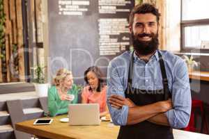 Waiter standing with arms crossed