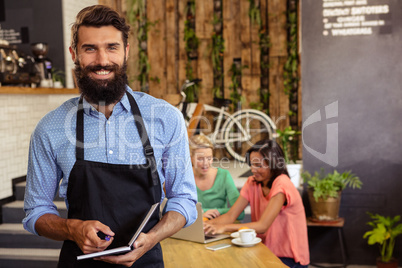 Waiter holding a book and pen