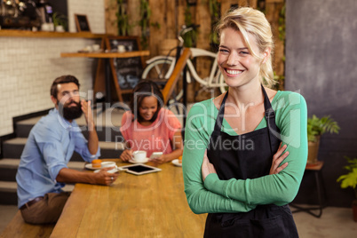 Waitress standing with arms crossed