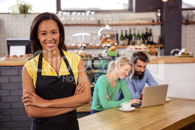 Waitress standing with arms crossed