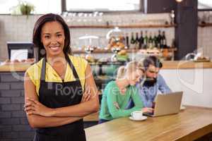 Waitress standing with arms crossed