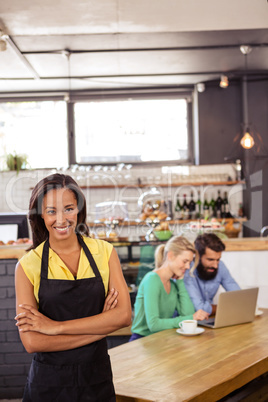 Waitress standing with arms crossed