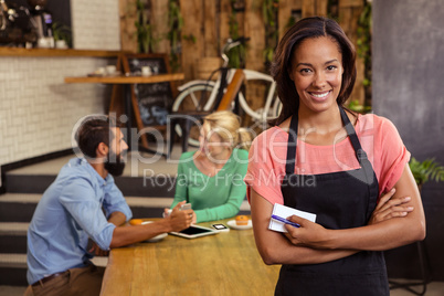 Waitress standing with arms crossed