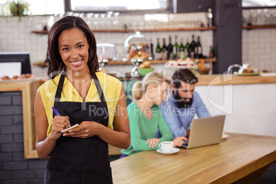 Waitress taking order on a notebook