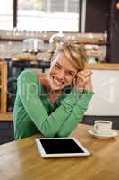 Woman sitting at a table sitting and smiling