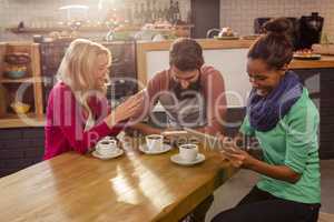 Friends using technology sitting