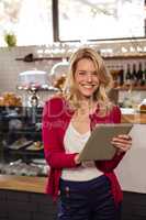 Woman using a tablet sitting and smiling