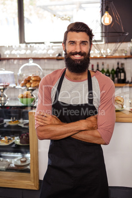 Waiter standing with arms crossed