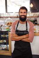 Waiter standing with arms crossed