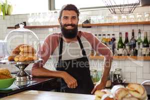 Waiter leaning against counter