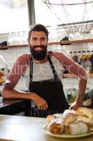 Waiter leaning against counter