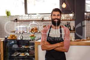 Waiter standing with arms crossed