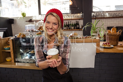 Waitress holding a disposable cup