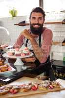 Man posing with cakes