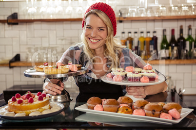 Waitress posing with cakes