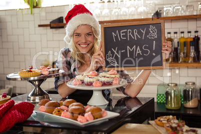 Woman holding blackboard with merry christmas