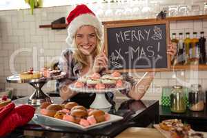 Woman holding blackboard with merry christmas