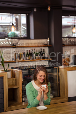 Smiling woman holding a cup of coffee