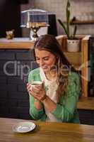 Smiling woman holding a cup of coffee