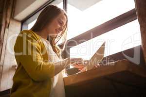 Smiling woman using a tablet
