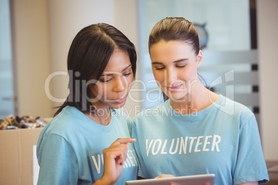 Volunteers using a tablet