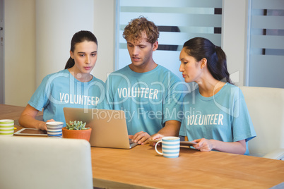 Volunteers using a laptop