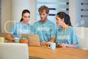 Volunteers using a laptop
