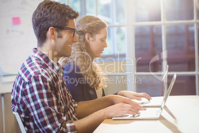 Two colleagues working on laptop