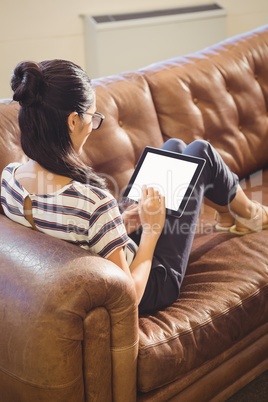 Businesswoman lying on a sofa