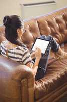 Businesswoman lying on a sofa