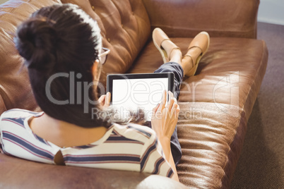 Businesswoman lying on a sofa