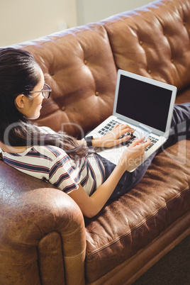 Business woman posing in front of her computer with her card