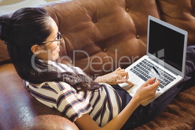 Business woman posing in front of her computer with her card