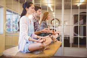 Business people doing yoga together