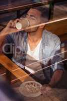 Portrait of hipster man eating and drinking