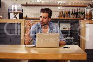 Portrait of hipster man sipping coffee