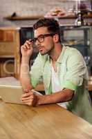 Portrait of hipster man using tablet