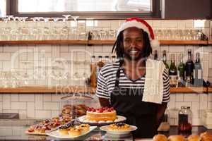 Happy hipster worker posing with Christmas hat