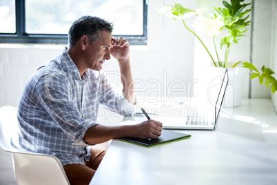 Businessman writing on a notepad