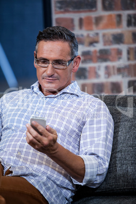 Close up of businessman looking his mobile phone