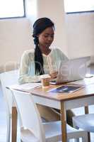 Portrait of businesswoman typing on her laptop