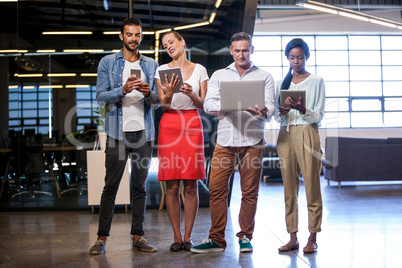 Business team posing with different technologies