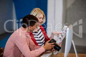 Profile view of photographer talking with his colleague