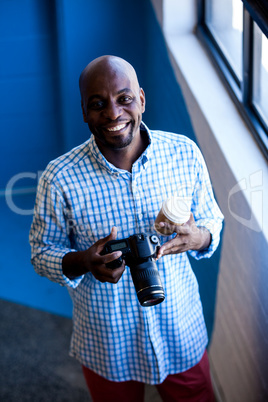 Portrait of photographer smiling with his camera