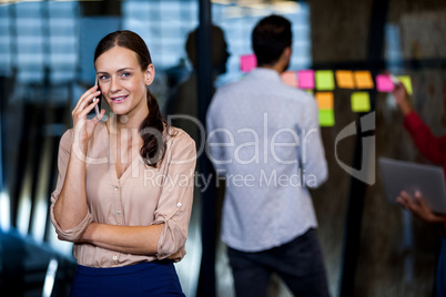 Focus on foreground of businesswoman calling