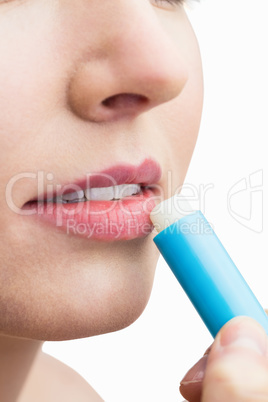 Woman applying lipstick