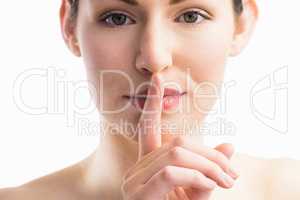Focus on woman with her finger on mouth