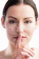 Focus on woman with her finger on mouth
