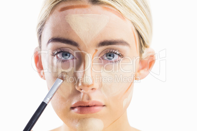 Woman doing contouring on her face