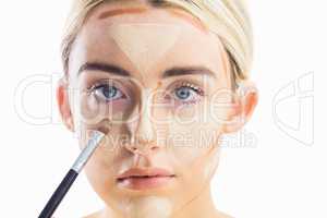 Woman doing contouring on her face